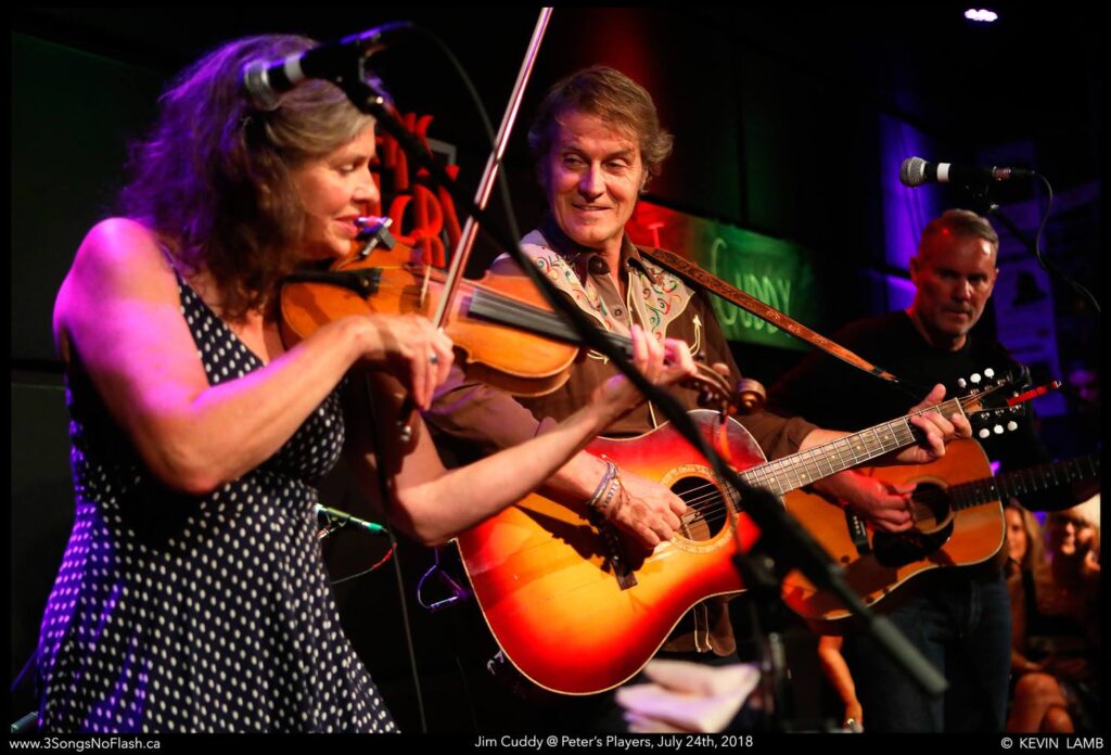 Peters Players fiddler and guitarist on stage