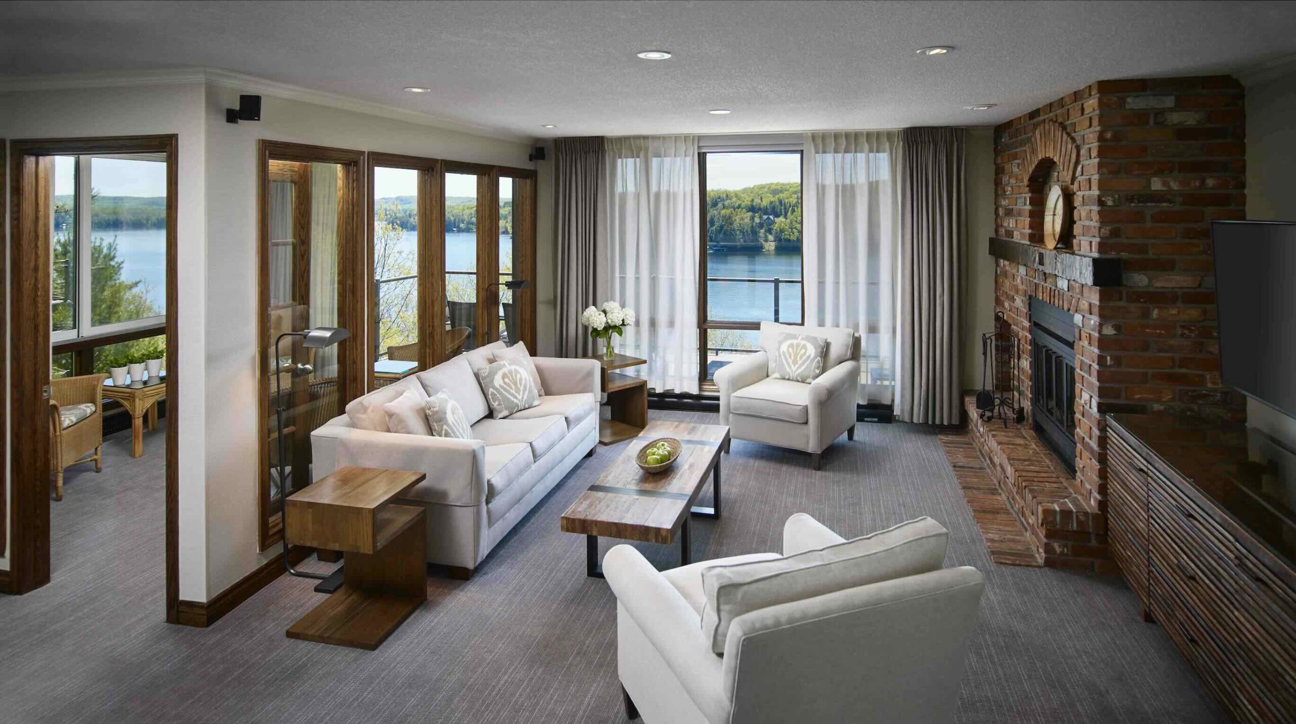 Condo Living Room lake view with sunroom at one of the best all-inclusive resorts in Ontario, Deerhurst Resort