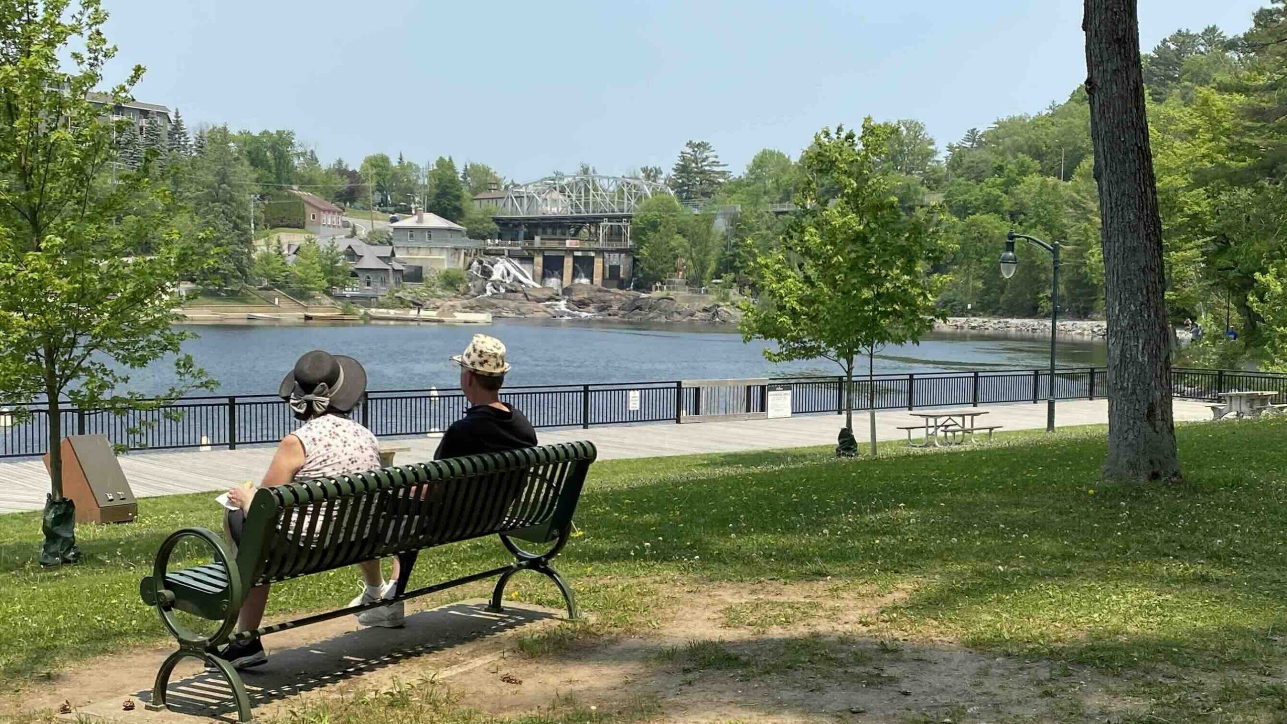 Bracebridge Falls with couple sitting on bench in front of one of the best waterfalls in Ontario photo by Bryan Dearsley