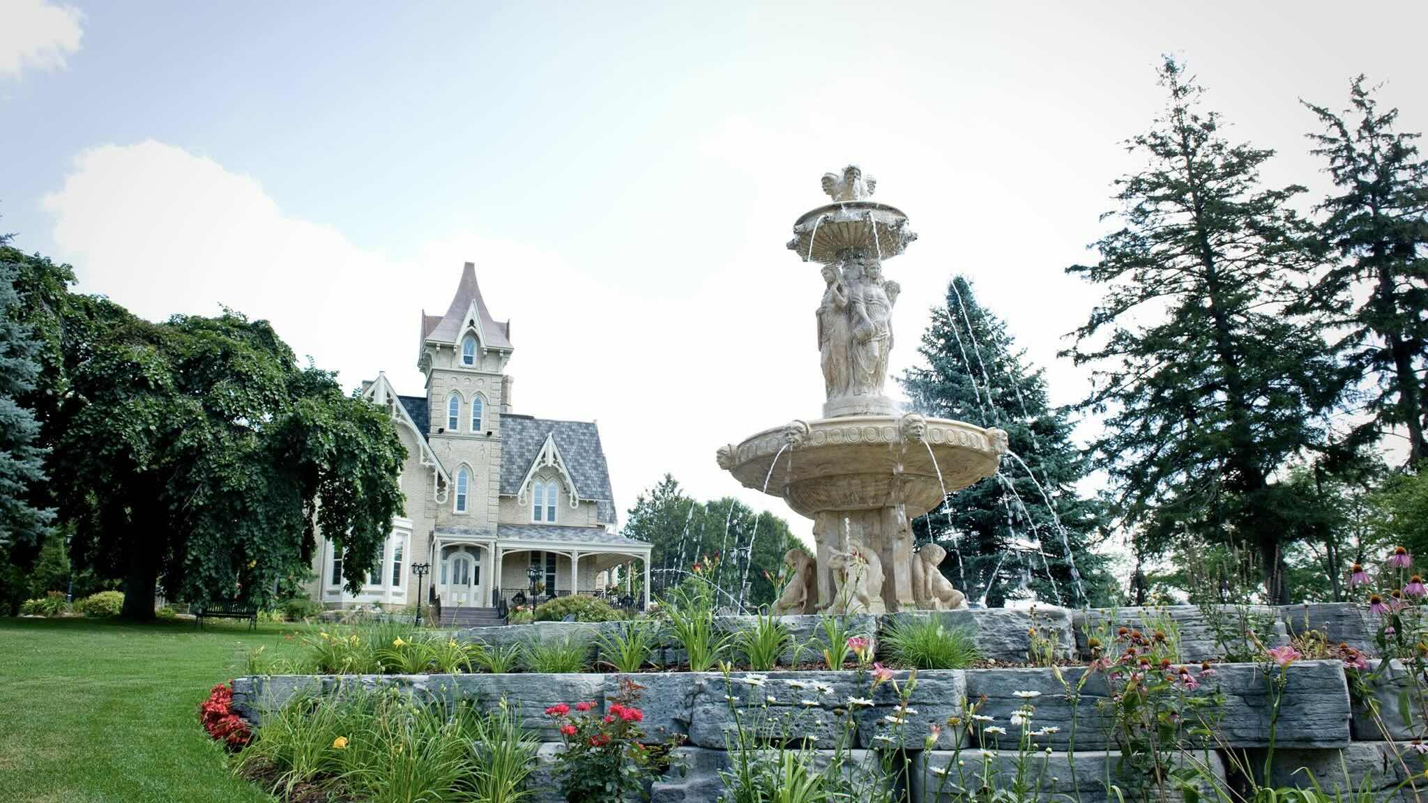ElmHurst Inn exterior in summer with fountain at one of the best luxury ontario inns