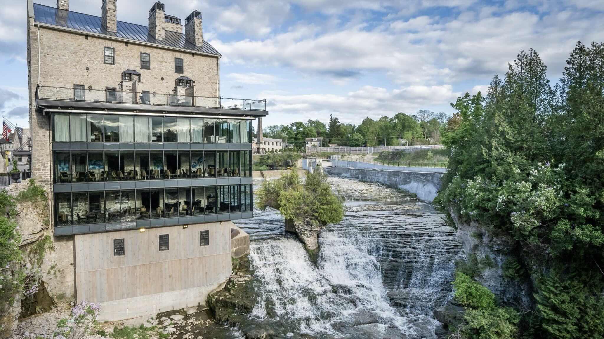 Elora Mill Hotel & Spa exterior of building and waterfalls