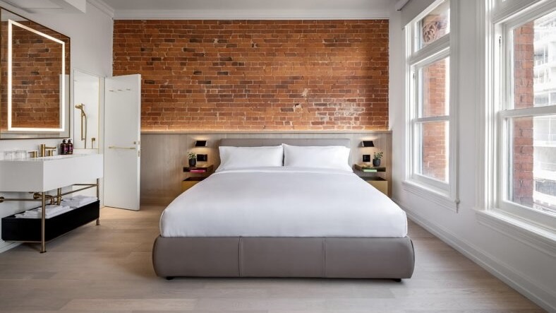Gladstone House interior with bed and exposed red bricks