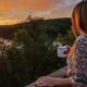 MFI H2H Cottage Co woman drinking coffee and watching sunset at one of the best luxury Haluburton cottage rentals